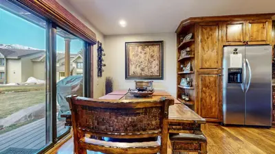 a kitchen with a wooden table and a refrigerator at Snowcreek 269 Condo in Mammoth Lakes