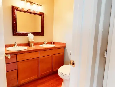 a bathroom with two sinks and a toilet at Sierra Manors 8 Townhouse in Mammoth Lakes