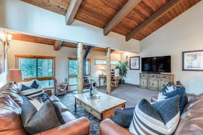 a living room with a couch and a coffee table at Courchevel 14 Condo in Mammoth Lakes
