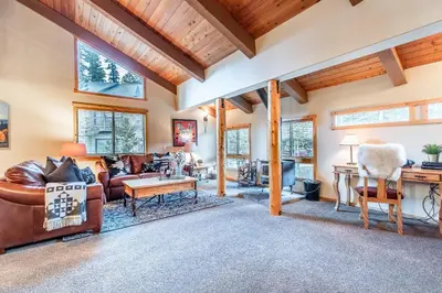 a living room with leather furniture and wooden ceilings at Courchevel 14 Condo in Mammoth Lakes
