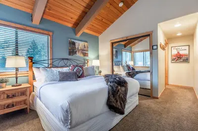 a bedroom with a large bed and a mirror at Courchevel 14 Condo in Mammoth Lakes