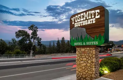 a sign on the side of a road at Yosemite Southgate Hotel & Suites in Oakhurst