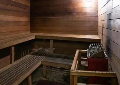 an empty sauna with two benches in a room at Yosemite Southgate Hotel & Suites in Oakhurst