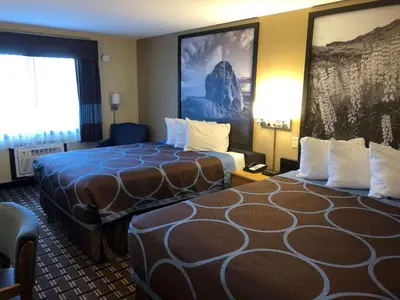 a hotel room with two beds and a window at Super 8 by Wyndham Carson City Lake Tahoe in Carson City