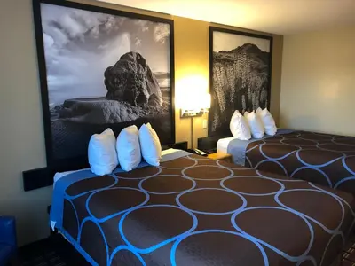 a hotel room with two beds and a picture on the wall at Super 8 by Wyndham Carson City Lake Tahoe in Carson City