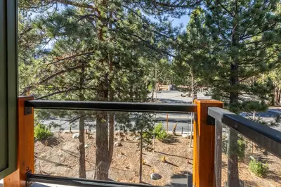 a balcony with a view of a park with trees at Solstice 6 in Mammoth Lakes