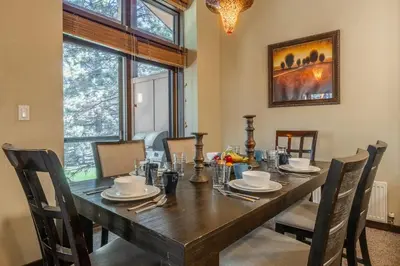 a dining room with a wooden table and chairs at Solstice 6 in Mammoth Lakes