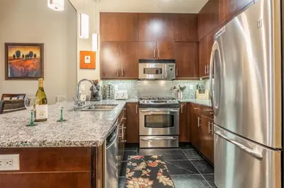 a kitchen with wooden cabinets and a stainless steel refrigerator at Solstice 6 in Mammoth Lakes