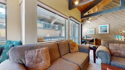 a living room with a couch and a window at Bigwood #62 Condo in Mammoth Lakes