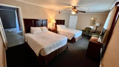 a hotel room with two beds and a bathroom at Yosemite View Lodge in El Portal