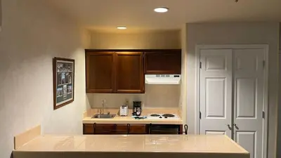a kitchen with wooden cabinets and a counter top at Yosemite View Lodge in El Portal