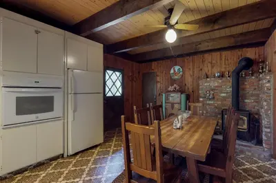 a kitchen with a wooden table and a ceiling fan at Ski View Majesty in Truckee