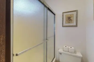 a bathroom with a toilet and a glass shower door at Ski View Majesty in Truckee