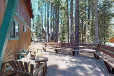 a porch of a house with chairs and trees at Ski View Majesty in Truckee