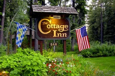a sign for the office inn with two american flags at Cottage Inn At Lake Tahoe in Tahoe City