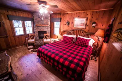 a bedroom with a bed with a red and black plaid blanket at Cottage Inn At Lake Tahoe in Tahoe City