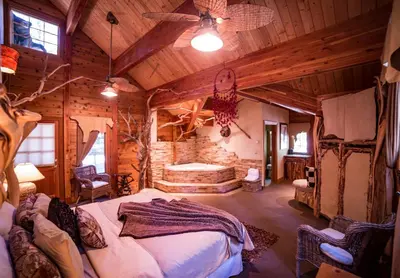 a bedroom with a large bed in a log cabin at Cottage Inn At Lake Tahoe in Tahoe City