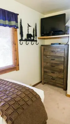 a bedroom with a bed and a tv on the wall at Ski Trails 4042 in Truckee