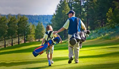 a man and a boy walking on a golf course at Catamount 407C in Truckee