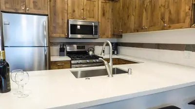 a kitchen with a sink and a stainless steel refrigerator at Ski Trails 4070 in Truckee