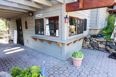 a store front with a flag in front of it at Ski Trails 4058 in Truckee