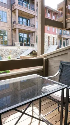 a glass table and a chair on a balcony at Northstar Village 216 in Truckee