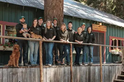 a group of people standing on a fence in front of a house at Silver City Mountain Resort in Sequoia National Park