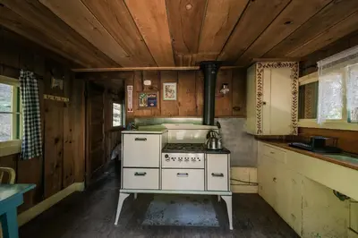 a kitchen with an old stove and wooden ceilings at Silver City Mountain Resort in Sequoia National Park