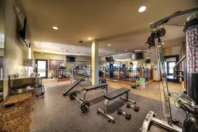 a gym with a bunch of equipment in a room at Hotel Mission De Oro in Santa Nella Village