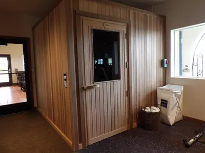 a hallway with a door in a room with a window at Hotel Mission De Oro in Santa Nella Village