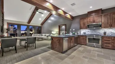 a kitchen with wooden cabinets and a living room at Zalanta 313 in South Lake Tahoe