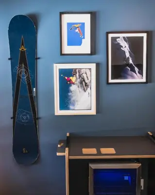 a room with a snowboard and pictures on a wall at evo Hotel Tahoe City in Tahoe City