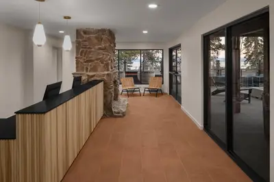 a hallway of a home with a fireplace and a stone pillar at evo Hotel Tahoe City in Tahoe City