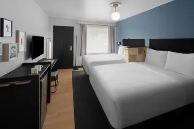 a hotel room with a large white bed and a desk at evo Hotel Tahoe City in Tahoe City