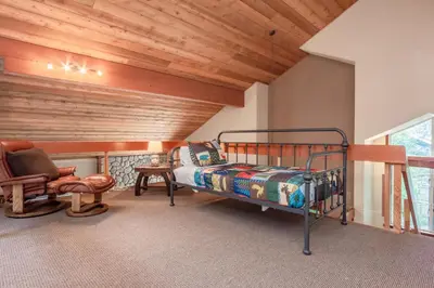 a bedroom with a bed and a wooden ceiling at Snowcreek IV 598 in Mammoth Lakes