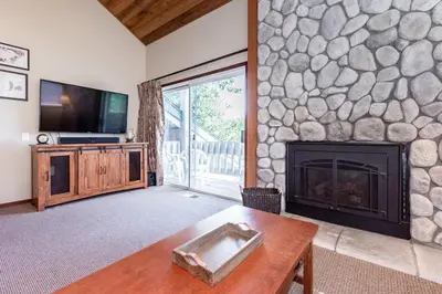 a living room with a fireplace and a tv at Snowcreek IV 598 in Mammoth Lakes