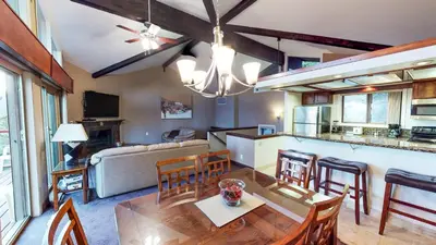 a kitchen and living room with a table and chairs at Tahoe Chaparral in Incline Village