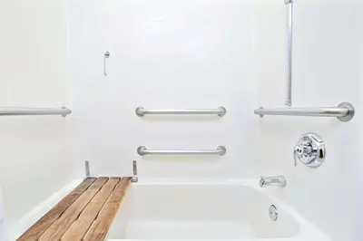 a bathroom with a bathtub with a wooden counter at Microtel Inn & Suites, Morgan Hill in Morgan Hill