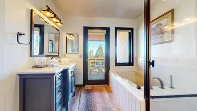 a bathroom with two sinks and a tub and a shower at Bridges Townhome #5 Condo in Mammoth Lakes