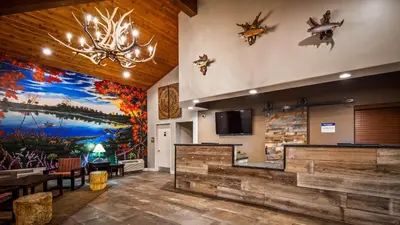 a lobby with a large painting of animals on the wall at Best Western Bishop Lodge in Bishop