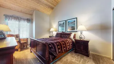a bedroom with a bed and a desk and a chair at Snowcreek 622 Condo in Mammoth Lakes