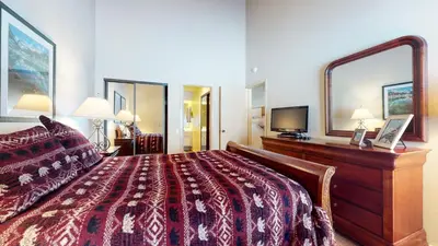 a hotel room with a bed and a large mirror at Snowcreek 622 Condo in Mammoth Lakes