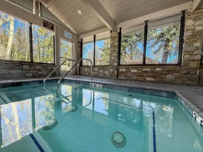 a large swimming pool in a home with windows at Snowcreek 622 Condo in Mammoth Lakes