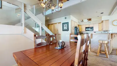 a kitchen and dining room with a wooden table at Snowcreek 622 Condo in Mammoth Lakes