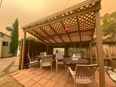 a wooden pergola with a table and chairs on a patio at Independence Courthouse Motel in Independence