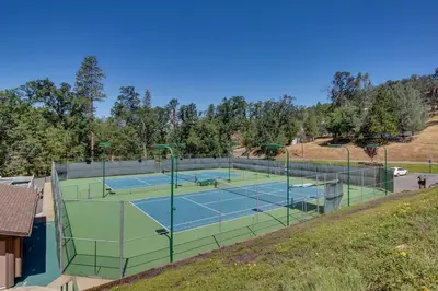 a tennis court on a hill with two tennis courts at Rustic Retreat in Groveland