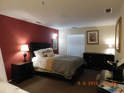 a bedroom with a bed and a red wall at Freeport Wine Country Inn in Freeport
