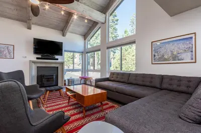 a living room with a couch and a fireplace at Courchevel C # 9 in Mammoth Lakes