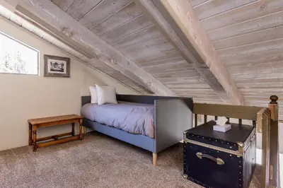 a small bedroom with a bed in a attic at Courchevel C # 9 in Mammoth Lakes