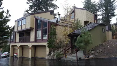 a house on a flooded street in the rain at Courchevel C # 9 in Mammoth Lakes